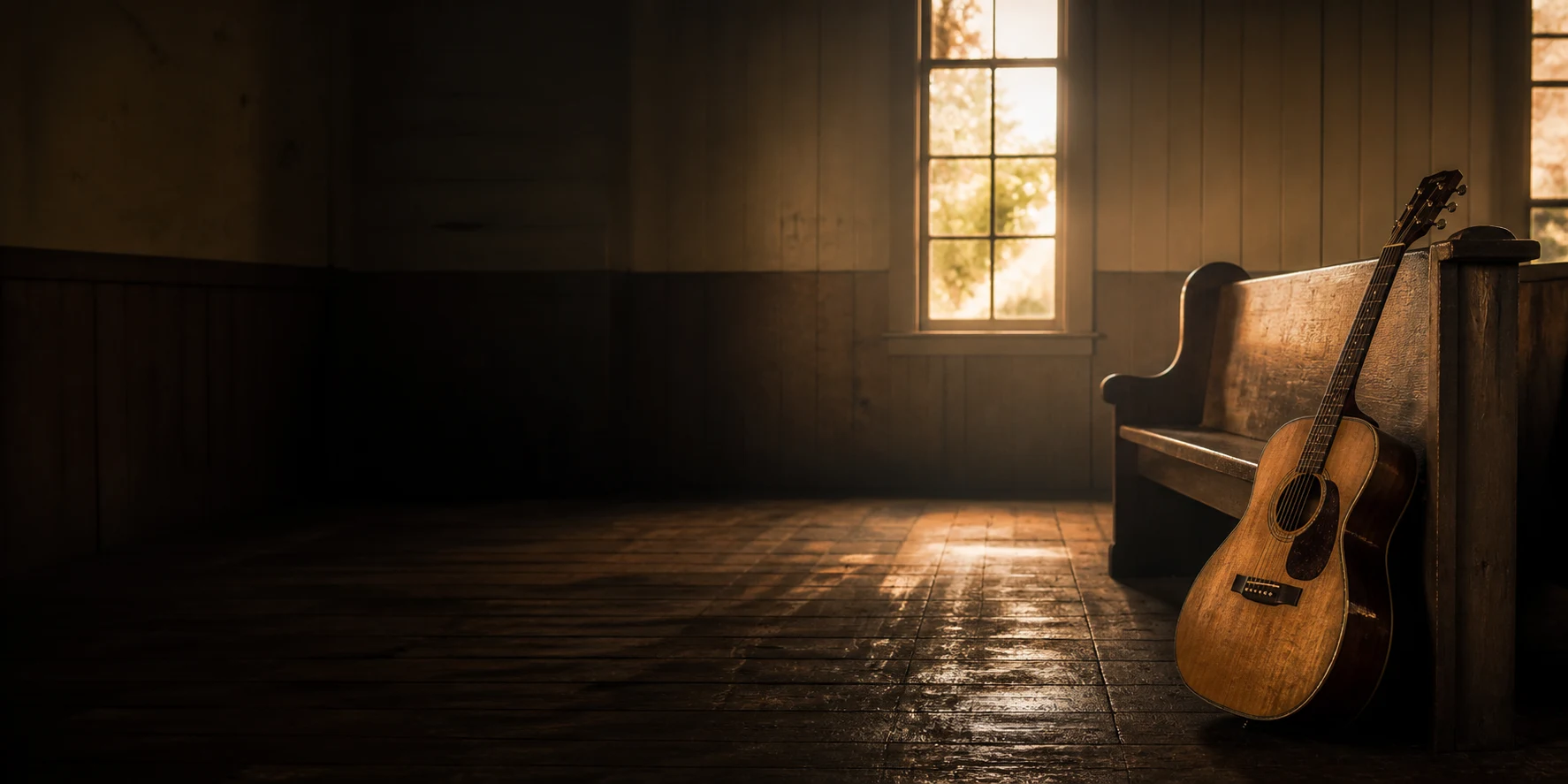 A well-worn acoustic guitar resting beside a church pew in warm evening light